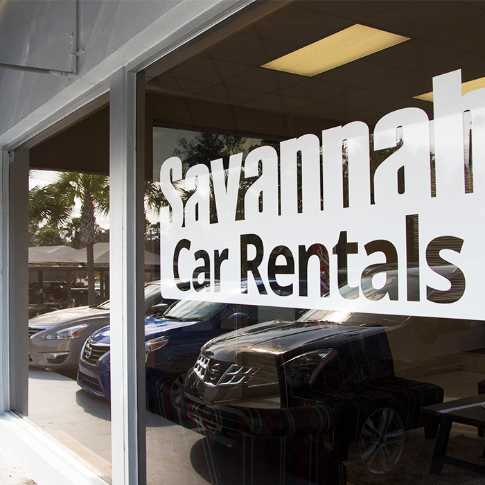 Front window of Savannah Car Rentals building